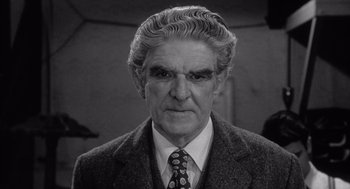 Movie still from “Raging Bull” (1980), directed by Martin Scorsese – An older man wearing a suit and a tie; Close Up shot, Low angle