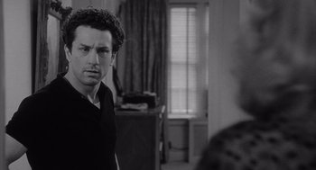 Movie still from “Raging Bull” (1980), directed by Martin Scorsese – A black and white photo of a man looking at a woman; Close Up shot, Over the shoulder angle