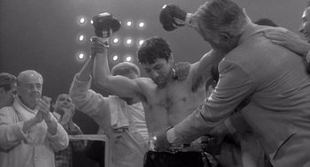 Movie still from “Raging Bull” (1980), directed by Martin Scorsese – A black - and - white photo of a man in a boxing ring; Medium shot, Low angle
