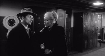 Movie still from “Raging Bull” (1980), directed by Martin Scorsese – A man and a woman standing next to each other in front of lockers; Medium shot, Over the shoulder angle