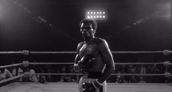 Movie still from “Raging Bull” (1980), directed by Martin Scorsese – Black and white photograph of a man in a boxing ring; Medium shot, Low angle