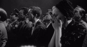 Movie still from “Raging Bull” (1980), directed by Martin Scorsese – A black and white photo of a group of men and women; Close Up shot, Over the shoulder angle