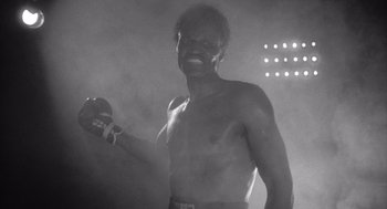 Movie still from “Raging Bull” (1980), directed by Martin Scorsese – A black and white photo of a man in a boxing ring; Medium shot, Low angle