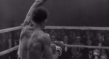 Movie still from “Raging Bull” (1980), directed by Martin Scorsese – A black and white photo of a man in a boxing ring; Close Up shot, Low angle