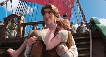 Movie still from “The Sea Beast” (2022), directed by Chris Williams – A man holding a young boy in his arms on top of a boat; Medium shot, Low angle