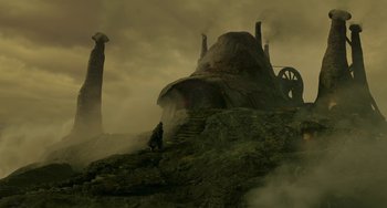 Movie still from “The Sea Beast” (2022), directed by Chris Williams – A person standing on a hill near a building; Extreme Wide shot, Low angle