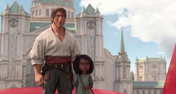 Movie still from “The Sea Beast” (2022), directed by Chris Williams – A man standing next to a little girl in front of a castle; Medium shot, Low angle