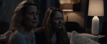 Movie still from “The Silence” (2019), directed by John R. Leonetti – Two women sitting next to each other in a dark room; Close Up shot, Over the shoulder angle