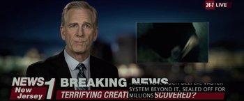 Movie still from “The Silence” (2019), directed by John R. Leonetti – A man in a suit and tie in front of a tv screen; Extreme Close Up shot, Over the shoulder angle