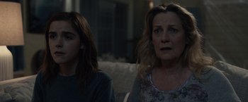 Movie still from “The Silence” (2019), directed by John R. Leonetti – Two women sitting on a couch in a living room; Close Up shot, Over the shoulder angle