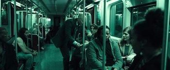 Movie still from “The Silence” (2019), directed by John R. Leonetti – A group of people riding on a train; Wide shot, High angle
