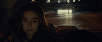 Movie still from “The Silence” (2019), directed by John R. Leonetti – A woman sitting in the back seat of a car at night; Close Up shot, Over the shoulder angle