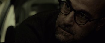 Movie still from “The Silence” (2019), directed by John R. Leonetti – A person wearing glasses; Close Up shot, Over the shoulder angle