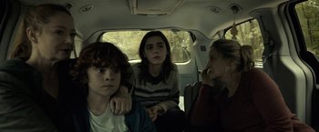 Movie still from “The Silence” (2019), directed by John R. Leonetti – A group of people sitting in the back of a car; Medium shot, Over the shoulder angle