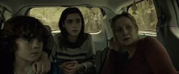 Movie still from “The Silence” (2019), directed by John R. Leonetti – Two people sitting in the back of a car; Medium shot, Over the shoulder angle