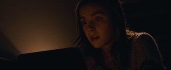 Movie still from “The Silence” (2019), directed by John R. Leonetti – A woman looking at a tablet computer in a dark room; Close Up shot, Low angle