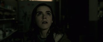 Movie still from “The Silence” (2019), directed by John R. Leonetti – A woman looking up in a dark room; Close Up shot, Low angle