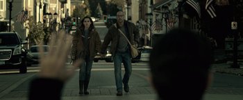Movie still from “The Silence” (2019), directed by John R. Leonetti – A man and a woman walking down a street holding hands; Medium shot, Over the shoulder angle