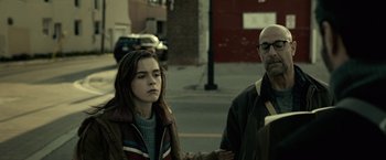 Movie still from “The Silence” (2019), directed by John R. Leonetti – A man and a woman walking down a street; Medium shot, Over the shoulder angle