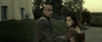 Movie still from “The Silence” (2019), directed by John R. Leonetti – A man and a woman standing next to each other in a field; Medium shot, Over the shoulder angle