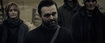 Movie still from “The Silence” (2019), directed by John R. Leonetti – A person wearing a jacket; Close Up shot, Over the shoulder angle