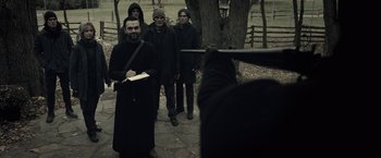 Movie still from “The Silence” (2019), directed by John R. Leonetti – A group of people standing next to each other; Medium shot, Over the shoulder angle