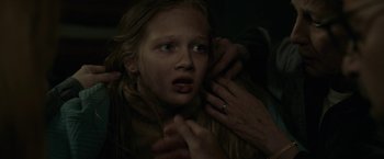 Movie still from “The Silence” (2019), directed by John R. Leonetti – A young girl with her hands on her face; Close Up shot, Over the shoulder angle