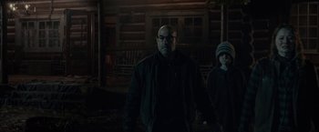 Movie still from “The Silence” (2019), directed by John R. Leonetti – A man and a boy are standing in the dark; Medium shot, Over the shoulder angle