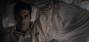 Movie still from “The Spy” (2019), directed by Gideon Raff – A man laying in a bed with his head on a pillow; Close Up shot, High angle