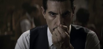 Movie still from “The Spy” (2019), directed by Gideon Raff – A person with his hand to his face; Close Up shot, Over the shoulder angle