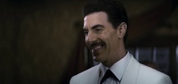 Movie still from “The Spy” (2019), directed by Gideon Raff – A person wearing a suit and tie; Close Up shot, Over the shoulder angle