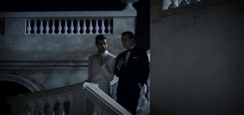 Movie still from “The Spy” (2019), directed by Gideon Raff – Two men in tuxedos standing next to each other; Medium shot, Low angle