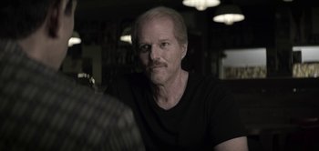 Movie still from “The Spy” (2019), directed by Gideon Raff – A person sitting in a room; Close Up shot, Over the shoulder angle