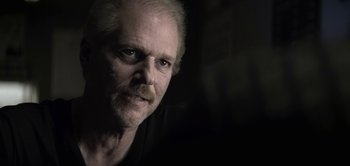 Movie still from “The Spy” (2019), directed by Gideon Raff – A person with a beard and mustache; Close Up shot, Over the shoulder angle