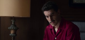 Movie still from “The Spy” (2019), directed by Gideon Raff – A man with a mustache wearing a red shirt; Close Up shot, Low angle