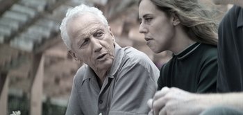 Movie still from “The Spy” (2019), directed by Gideon Raff – An older man and a younger woman are talking; Close Up shot, Over the shoulder angle