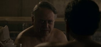 Movie still from “The Spy” (2019), directed by Gideon Raff – An older man looking into a mirror in a bathroom; Close Up shot, Over the shoulder angle