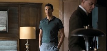 Movie still from “The Spy” (2019), directed by Gideon Raff – A man standing in front of a mirror in a room; Medium shot, Over the shoulder angle