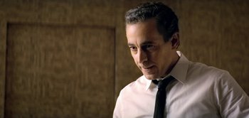 Movie still from “The Spy” (2019), directed by Gideon Raff – A person wearing a shirt and a tie; Close Up shot, Low angle