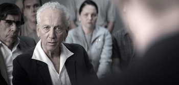 Movie still from “The Spy” (2019), directed by Gideon Raff – An old man and a young woman in a room; Close Up shot, Over the shoulder angle