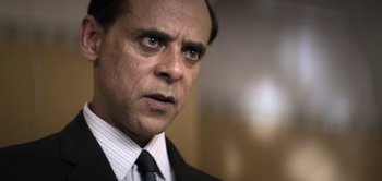 Movie still from “The Spy” (2019), directed by Gideon Raff – A person wearing a suit and tie; Close Up shot, Low angle