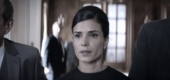 Movie still from “The Spy” (2019), directed by Gideon Raff – A person wearing a black shirt; Close Up shot, Over the shoulder angle