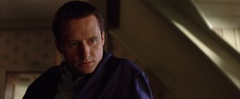 Movie still from “Batman Begins” (2005), directed by Christopher Nolan – A person wearing a robe; Close Up shot, Low angle