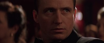 Movie still from “Batman Begins” (2005), directed by Christopher Nolan – A man's face in the dark; Close Up shot, Low angle