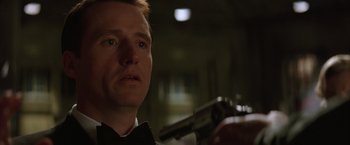 Movie still from “Batman Begins” (2005), directed by Christopher Nolan – A person holding a gun; Close Up shot, Low angle