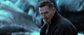 Movie still from “Batman Begins” (2005), directed by Christopher Nolan – A person with a beard; Close Up shot, Low angle