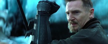 Movie still from “Batman Begins” (2005), directed by Christopher Nolan – A person holding a sword; Close Up shot, Low angle