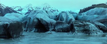 Movie still from “Batman Begins” (2005), directed by Christopher Nolan – A man standing in the middle of an ice cave; Extreme Wide shot, High angle