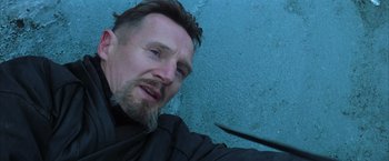 Movie still from “Batman Begins” (2005), directed by Christopher Nolan – A person holding a pair of scissors; Close Up shot, Low angle