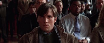 Movie still from “Batman Begins” (2005), directed by Christopher Nolan – A person wearing a jacket; Close Up shot, Low angle